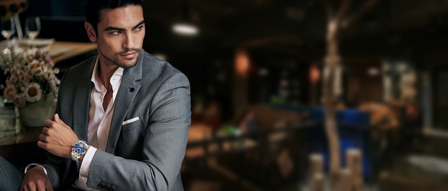 Man in grey suit wearing blue watch